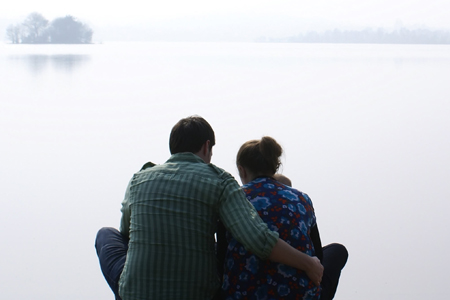 taken from back - family sits near water