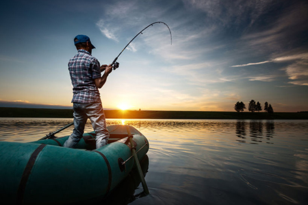 cropped image of fishing rod in front of water