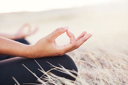 Woman meditating practicing yoga outdoors