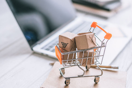 selective focus of decorative packages in toy cart on wooden desk