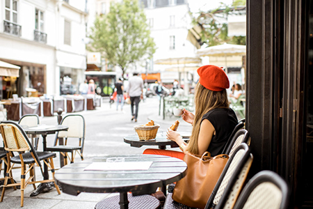 Woman having a french breakfast at the cafe