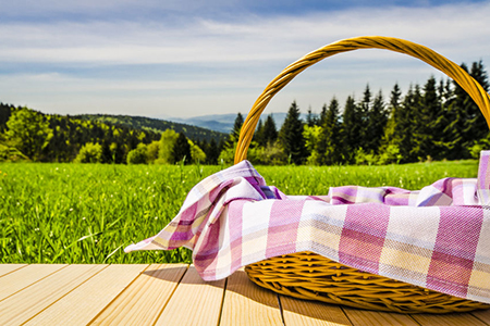 Picnic basket on wooden table