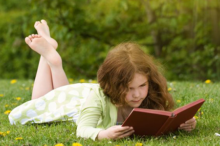 Girl reading in the grass