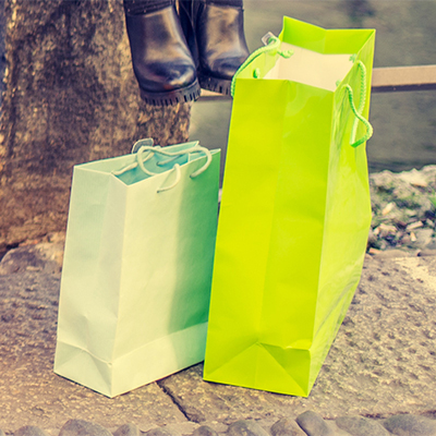 Two green shopping bags with handle.