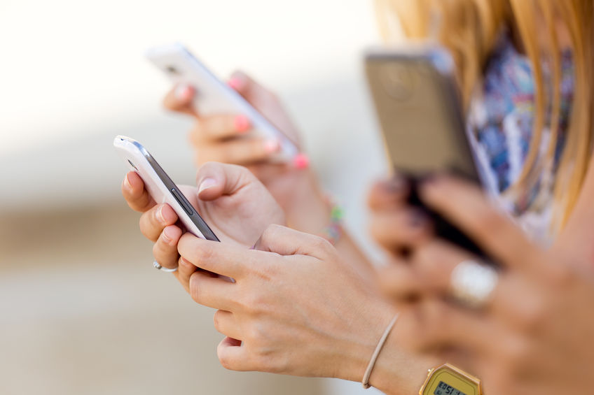 cropped image of hands using smartphones