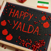 Happy Yalda night written on the board, pomegranate inscription on blackboard