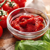 Bowl with tomato sauce on table