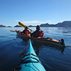 overjoyed woman in life vest paddling kayak