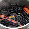 cooking chicha morada, a peruvian purple corn drink