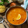 Traditional soup with rice, lentils and mint on a rustic table