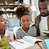 Mom and dad helping daughter with homework