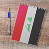 Notepad with Iraq flag, pen on wooden background