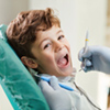 Beautiful child smiling while sitting in the dentists chair. close-up.