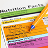 Nutrition facts and ballpoint pen. Close-up.