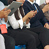 Young people using mobile phone in public underground train 