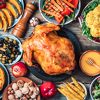 Roasted whole chicken, rice, pumpkin, corn, honey, nuts, vegetable salads over wooden background