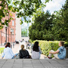 Students sitting on stairs outside university