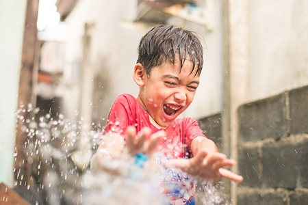 boy being sprayed with water