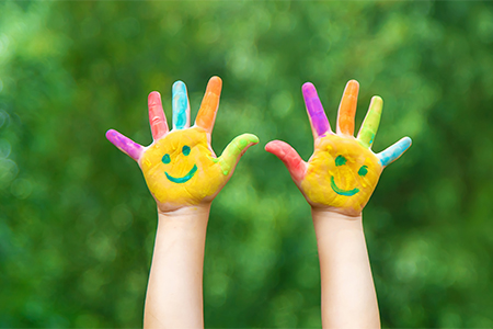 Child hands in paints a smile