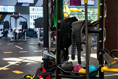 Modern gym interior with sports training equipment on rack