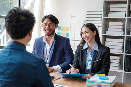 team analyzing charts and graphs with laptop on side