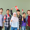 Group of adults with Canadian flags on color background