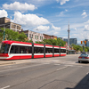 A view of cars and a subway in the streets of Toronto, Canada