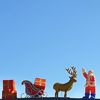Christmas display,decorations,Santa,reindeer,sleigh,minimal,clear blue sky