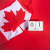 Canada Day concept with Canadian flag fragment and July 1 date on white wooden calendar