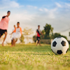 Children playing soccer football on field