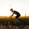 Cyclist on the racing bike at sunset
