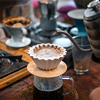 Drip coffee, barista pouring water on coffee ground with filter