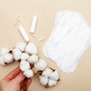 health care concept: Women's hygiene pads with tampons, flower cotton on a beige background