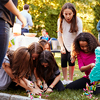 Young girls collecting sweets from a broken pi–ata