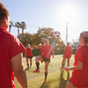 Womens Football Team Kicking Ball Whilst Training For Soccer Match