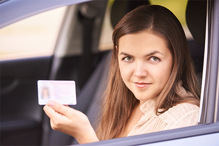 A girl showing her driving license