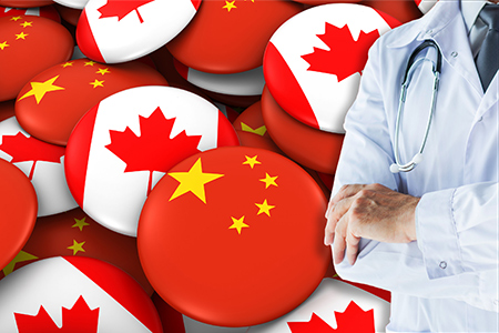 Doctor standing with stethoscope on China and Canada flags background