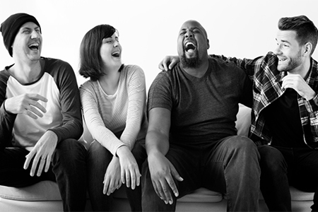 Group of diverse friends hanging out together and laughing