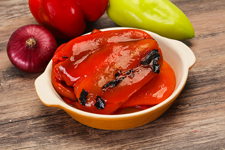 Marinated baked red bell pepper in the bowl