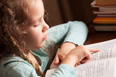 little girl reading a book