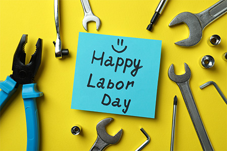 Concept of Happy Labor Day with different accessories on yellow background