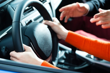 cropped image of hands on steering wheel during test