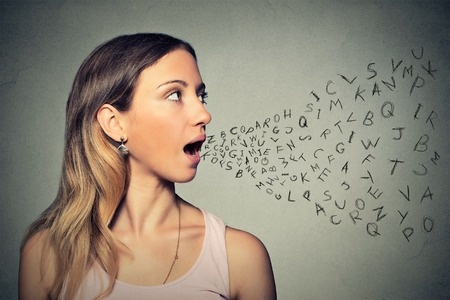 woman speaking - letters on wall