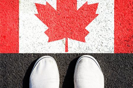 Sneakers and the canada flag. view from above. travels.