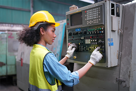 Portrait of a female apprentice in a factory