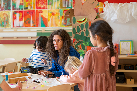 Happy encouraging teacher speaking to her class