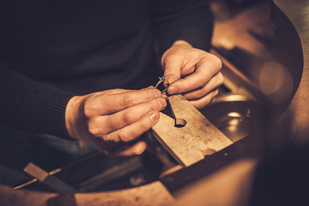 Jeweler at work in jewelery workshop