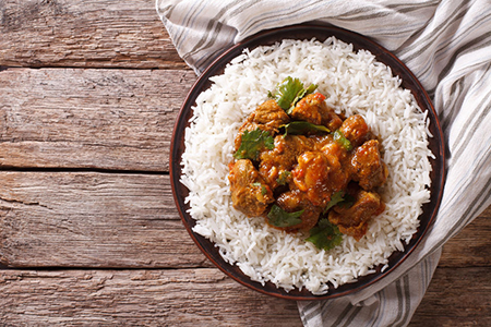 Indian food: Madras beef with basmati rice on the table. horizontal view from above