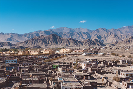 Landscape and building in city with mountains and blue sky background