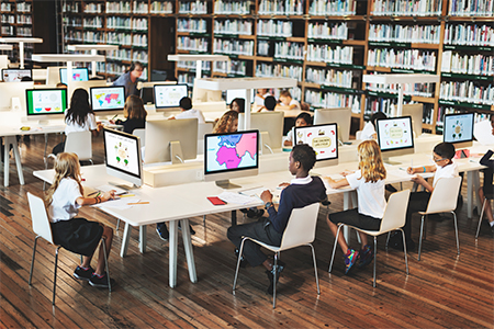 Young students using computers in libraries